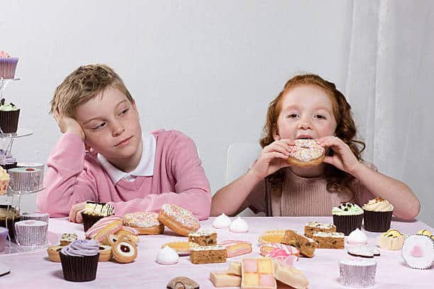 crianças comendo excesso de doces